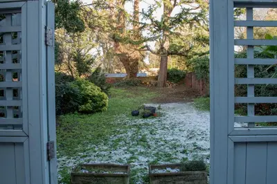 an open door to a yard with snow on the ground at Toothbrush Apartments - Central Ipswich - Fonnereau Road in Ipswich