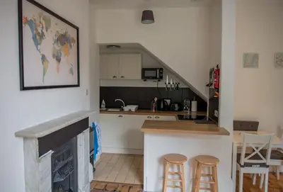 a kitchen with a counter and stools in a room at Toothbrush Apartments - Central Ipswich - Fonnereau Road in Ipswich