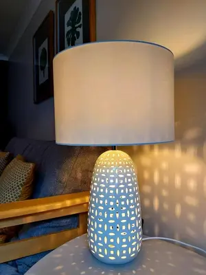 a lamp sitting on a table in a bedroom at 1 WATER PUMP HOUSE in Bury Saint Edmunds