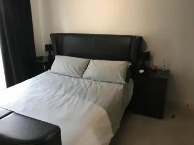 a bed with a black headboard and white sheets and pillows at Toothbrush Apartments - Ipswich Waterfront - The Cambria in Ipswich