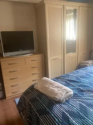 a bedroom with a bed and a flat screen tv at 2 bedrooms Bell Cottage in Hoddesdon