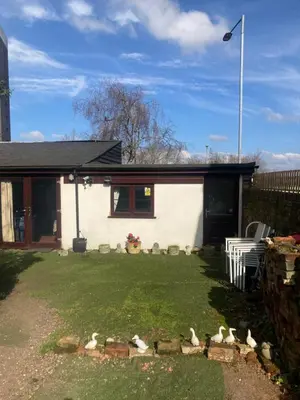a house with a bunch of birds in the yard at 2 bedrooms Bell Cottage in Hoddesdon