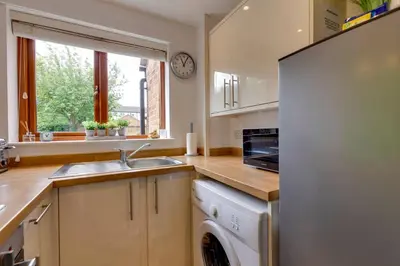 a kitchen with a sink and a washing machine at Fully refurbished 1 bedroom in Cambridge