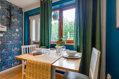 a dining room with a table and a window at Fully refurbished 1 bedroom in Cambridge