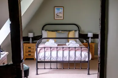 a bedroom with a bed with two towels on it at The Cross Keys, Aldeburgh in Aldeburgh
