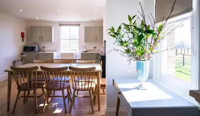 a kitchen and a dining room with a table and chairs at Longstowe Farmhouse in Longstowe