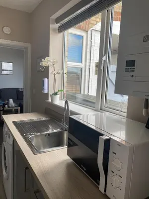 a kitchen with a sink and a counter top at Eclipse Apartment No 1 in Newmarket