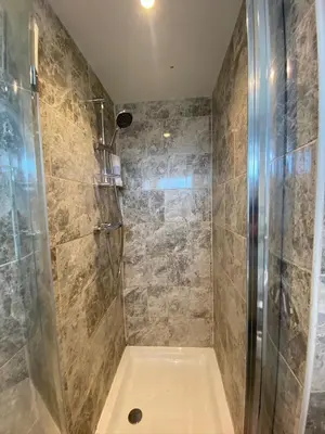 a bathroom with a shower with a glass door at Eclipse Apartment No 1 in Newmarket