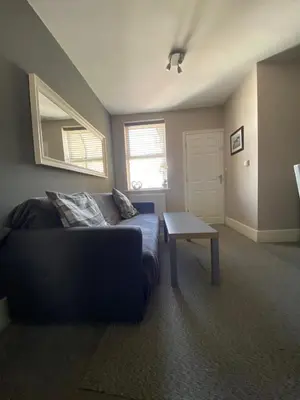 a living room with a couch and a table at Eclipse Apartment No 2 in Newmarket