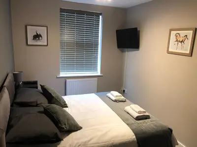 a bedroom with a bed with two towels on it at Eclipse Apartment No 2 in Newmarket