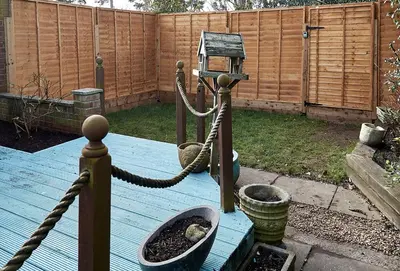 a garden with a rope tied to a bird house at Sunshine Corner in West Mersea