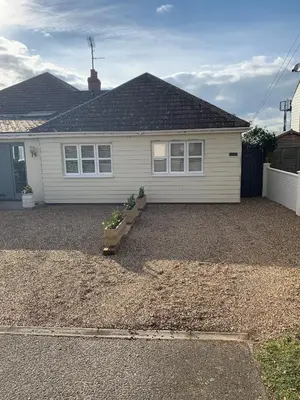 a house with a gravel driveway in front of it at Sunshine Corner in West Mersea