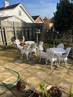 a patio with tables and chairs and a hose at Seaside resort in Felixstowe