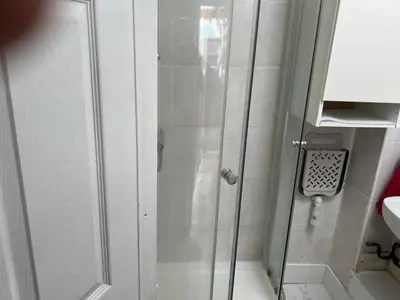 a shower with a glass door in a bathroom at Seaside resort in Felixstowe