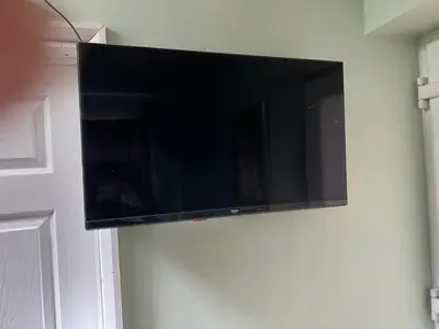 a flat screen tv hanging on a wall at Seaside resort in Felixstowe