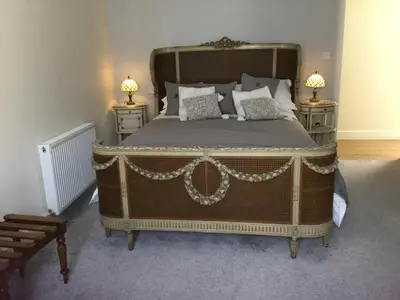 a bedroom with a large bed with two night stands at Eight ball house in Southburgh