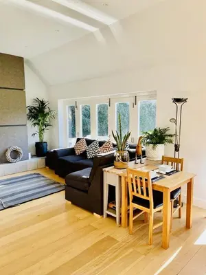 a living room with a table and a couch at The Thorpe Guesthouse in Huntingdon