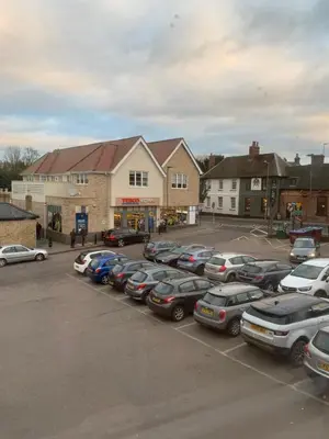 a parking lot with a bunch of cars parked at Market Hill Apartments in Royston