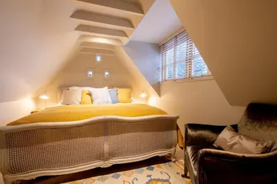 a bedroom with a large bed in a attic at Church Farm Lodge in Aldeburgh