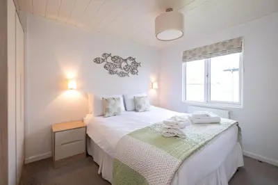a bedroom with a bed and a window at Horizon Lodge in Sizewell
