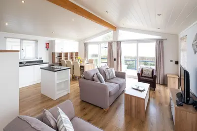 a living room with a couch and a table at Horizon Lodge in Sizewell