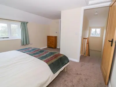 a bedroom with a white bed and a window at The Granary in Halstead