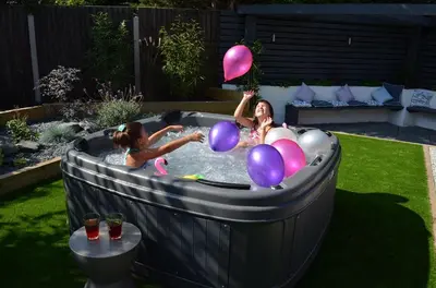 two girls playing in a hot tub with balloons at Corner Farm Barn in Halesworth
