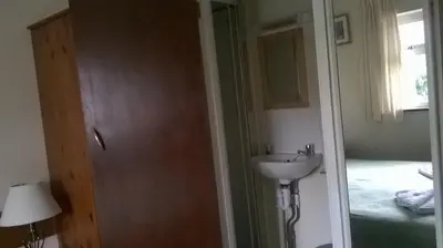 a bathroom with a sink and a mirror at Carlton Lodge in Cambridge