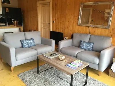 a living room with two couches and a coffee table at The Orchard Bramble Lodge in Hadleigh