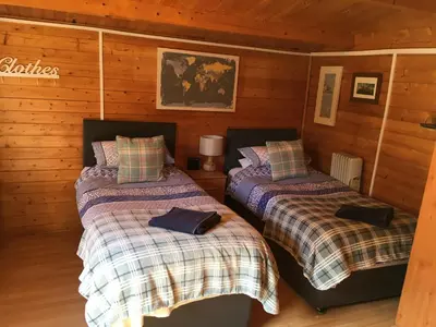 a bedroom with two beds in a cabin at The Theberton Lion in Theberton
