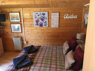 a room with a bed in a log cabin at The Theberton Lion in Theberton