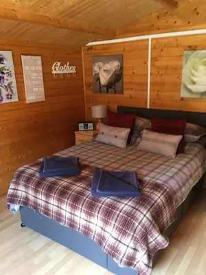 a bedroom with a bed in a cabin at The Theberton Lion in Theberton