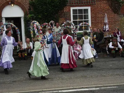 a group of people in dresses walking down a street at The Theberton Lion in Theberton