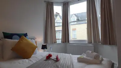 a bedroom with a bed and a large window at The Mill Suites - Tas Accommodations in Cambridge