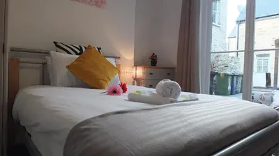 a white bed with stuffed animals on top of it at The Mill Suites - Tas Accommodations in Cambridge