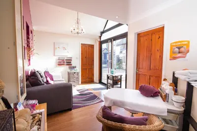 a living room with a couch and a table at Hunters Meet in Bishops Stortford