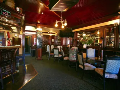 a bar with chairs and tables in a restaurant at The Ship in Chelmsford