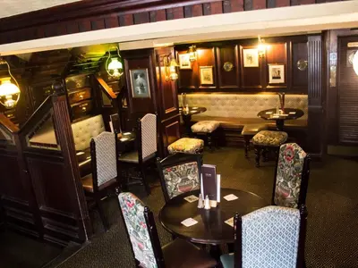a restaurant with tables and chairs in a room at The Ship in Chelmsford