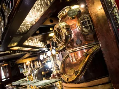 a bar with a diving helmet on the counter at The Ship in Chelmsford