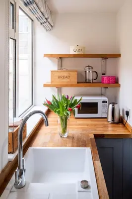 a kitchen with a sink and a microwave at Puddleduck Cottage in Aldeburgh