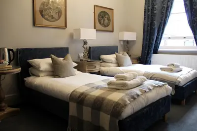 a bedroom with two beds with towels on them at The Blue Boar - Maldon in Maldon