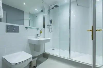 a bathroom with a shower and a toilet and a sink at The Blue Boar - Maldon in Maldon
