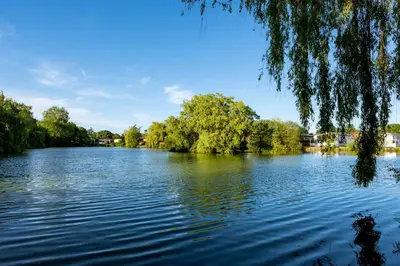 a view of a river with trees on the side at Camping Pods, Carlton Meres Holiday Park in Rendham