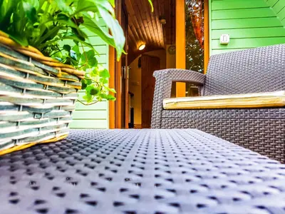 a table and two chairs on a porch at Colemans Cottage Fishery in Wickham Bishops