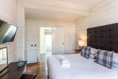 a bedroom with a bed with towels on it at Roydon Marina Village Lodges in Roydon