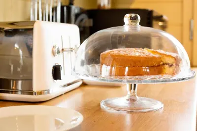 a cake in a glass dish on top of a counter at Sunset log cabin in Sudbury