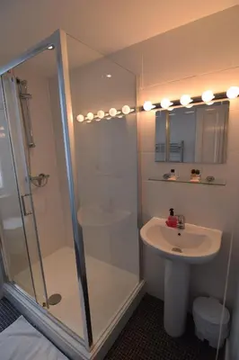 a bathroom with a shower and a sink at Castle Lodge in Ely