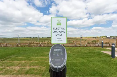a sign that reads electric charging only in a field at The Aviator, formerly Smugglers Cove, Clacton On Sea by Marston's Inns in Clacton-on-Sea