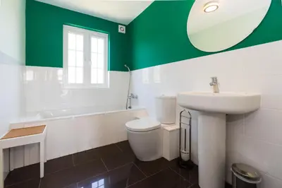 a bathroom with a sink and a toilet and a tub at Lake Cottage - A large holiday home in Thorpeness - Close to the beach and The Meare - Aldeburgh Coastal Cottages in Thorpeness