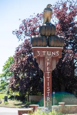 a sign with a bird sitting on top of it at Oak - Three Tuns Apartments, Pettistree, Wickham Market - by Aldeburgh Coastal Cottages in Pettistree